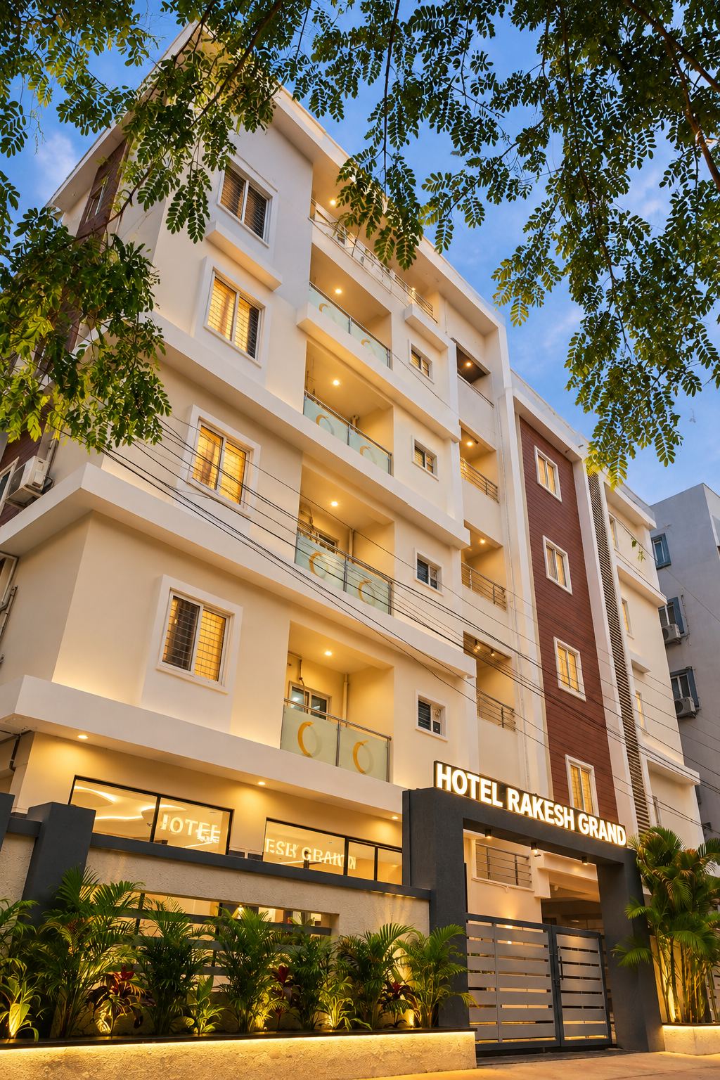Hotel Rakesh Grand building at dusk, Prashanth Hills, Hyderabad